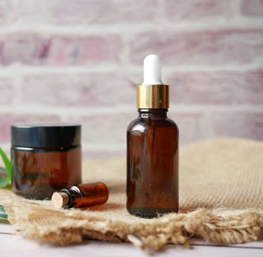 a bottle of essential oils and a jar of essential oils