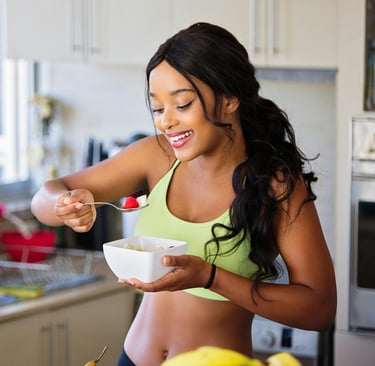a woman in a green top and a bowl of food