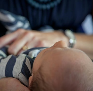 baby held by two hands