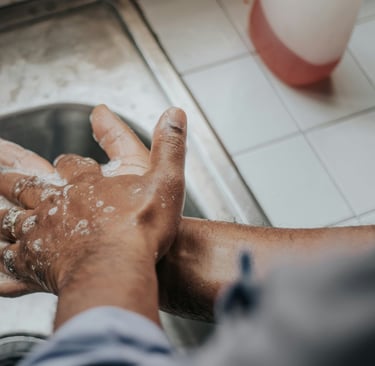 man washing hands with soap