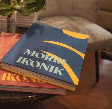 Moris Ikonik coffee table books on a rattan table in Mauritius