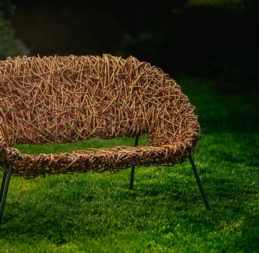 Bespoke 2-seater willow chair with modern green metal frame, handwoven design