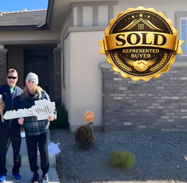 a man and woman standing in front of a sold sign
