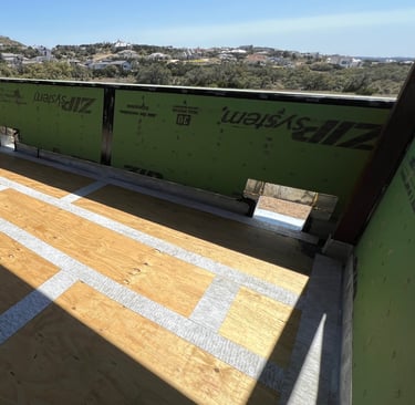 Waterproofing plywood joints before apply membrane and concrete on custom home balcony.