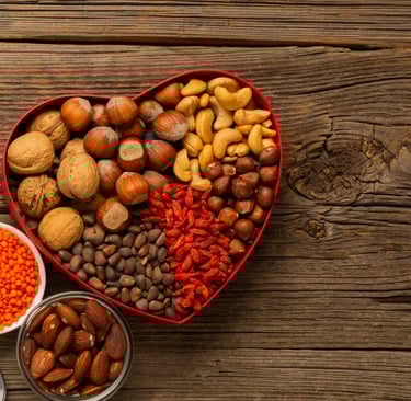 a heart shaped bowl with nuts