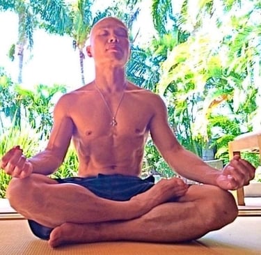 JEET KUNE DO BUDDHA sitting in a meditation position on a yoga mat.