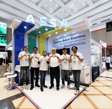 a group of people standing around a display of a group of people