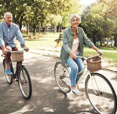 Older man and woman in a park in Carbondale, CO able to bike after peripheral neuropathy treatment