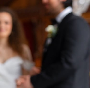 a man in a suit and tie is holding a camera