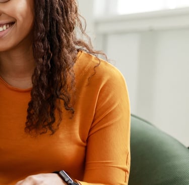 Woman smiles as she speaks to mediator on her laptop