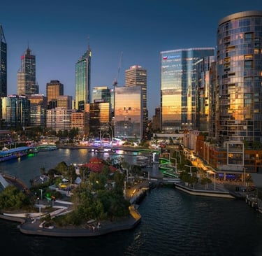 city skyline at sunset, featuring Quay and River with illuminated buildings and a pedestrian bridge