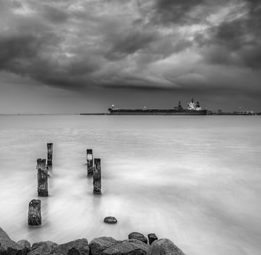 grey scale picture of port with ship loading