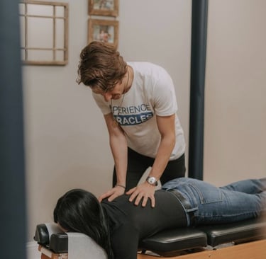 Pregnant woman receiving gentle prenatal chiropractic adjustment in Franklin TN