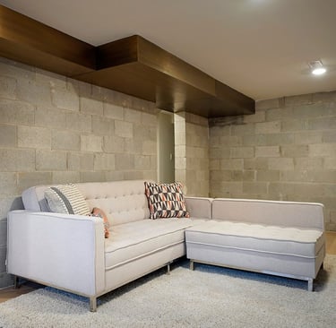 Home interior brass air vent above a couch, made by Pengelly Iron Works