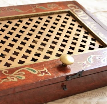 a wooden box with a golden handle