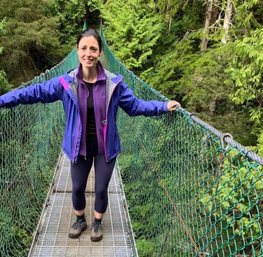 Brava Braun standing on a suspension bridge
