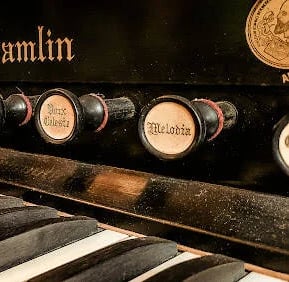 Lafayette - An 1800's piano in the grand hallway at the Marsh House
