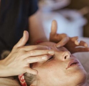 A woman getting a face massage during her facial.