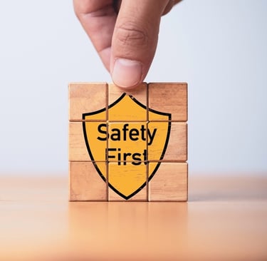 Building blocks with the graphic of a yellow shield saying "Safety First" on the front