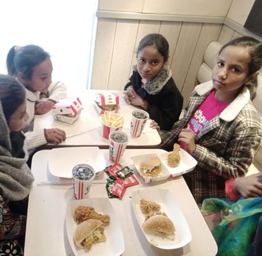 Sunday School children at Water of Life Ministries having lunch burgers and drinks