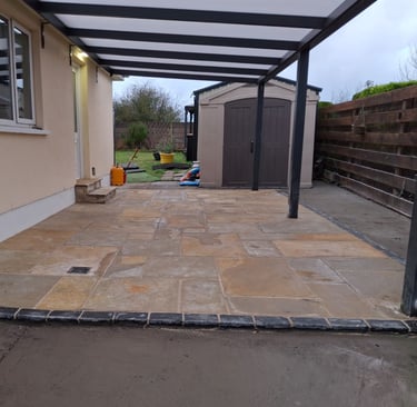 The after picture of construction which features a newly laid patio