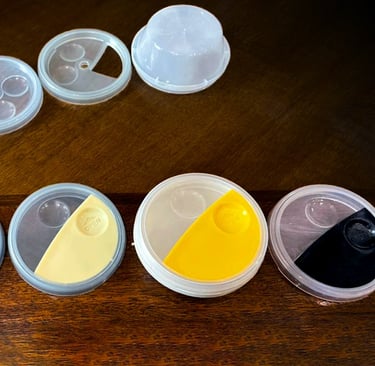 Injection molded disposable sauce containers in various colors, designed by Koorosh Shojaei, 1