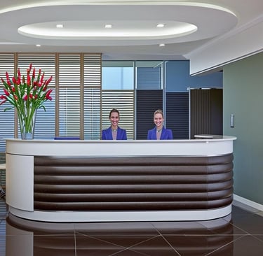 2 staff behind a reception desk