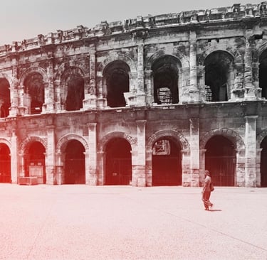 a man standing in front of a large colliseum arena
