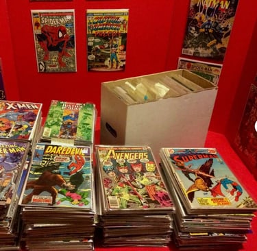 a table with a lot of comics books and comics