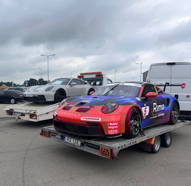 an Enlab Porsche race car being towed by a trailer