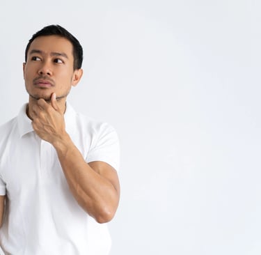 a man in a white shirt and jeans standing in front of a white wall