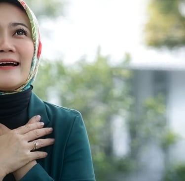a woman in a green shirt and a red scarf