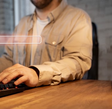 a man sitting at a desk with a keyboard and a keyboard
