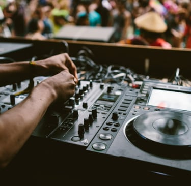 a dj mixing up a music event using a djm mixer