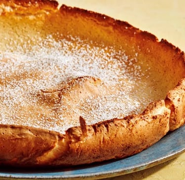 Dutch baby puffed pancake on a blue plate