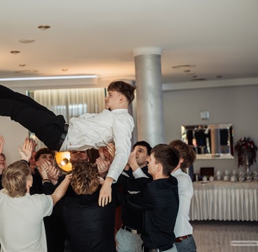 a man is doing a trick on a man in a suit and tie