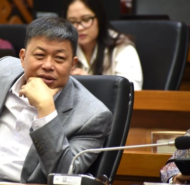 a man in a suit and tie sitting at a table