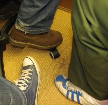 Trois pieds chaussés de trois chausures de style différent