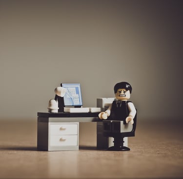 Lego minifigure at a desk symbolizing the challenges and frustrations of international students