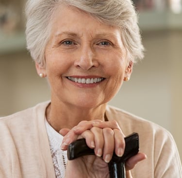 A smiling woman with dentures.