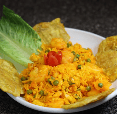 a plate of shrimp with rice and tostones