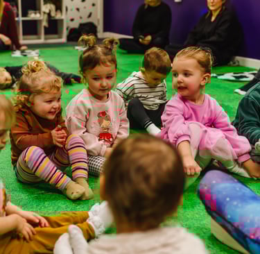 Young children as friends,sitting together watching farmer Becca in class.