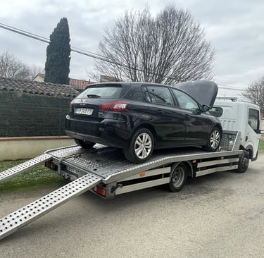 a car being towed down a street in a driveway