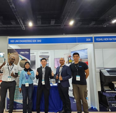 NSE Link Engineering team posing at their professional trade show booth during a construction industry exhibition.