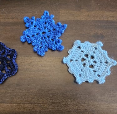 blue crochet snowflakes on a wooden background