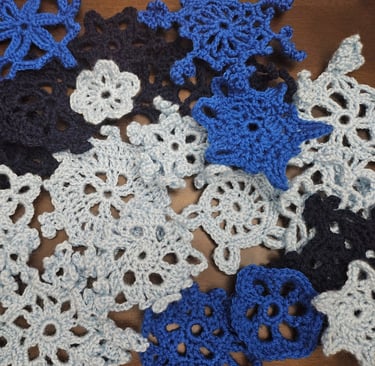 crochet snowflakes on a wooden table