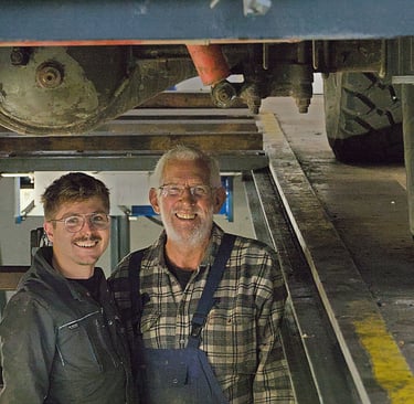 a man and a woman standing in front of a truck