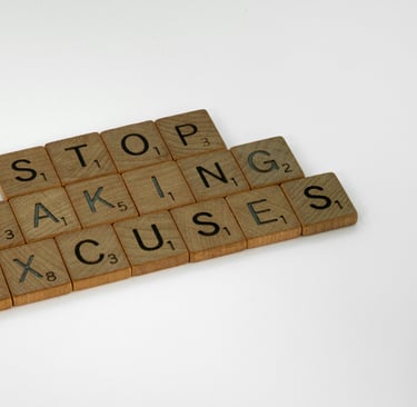 a wooden block with words that spell out the word stop making excuses