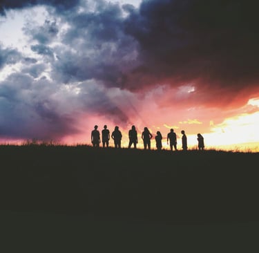 a group of people standing on a hill top