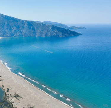 İztuzu Beach with a mountain in the background